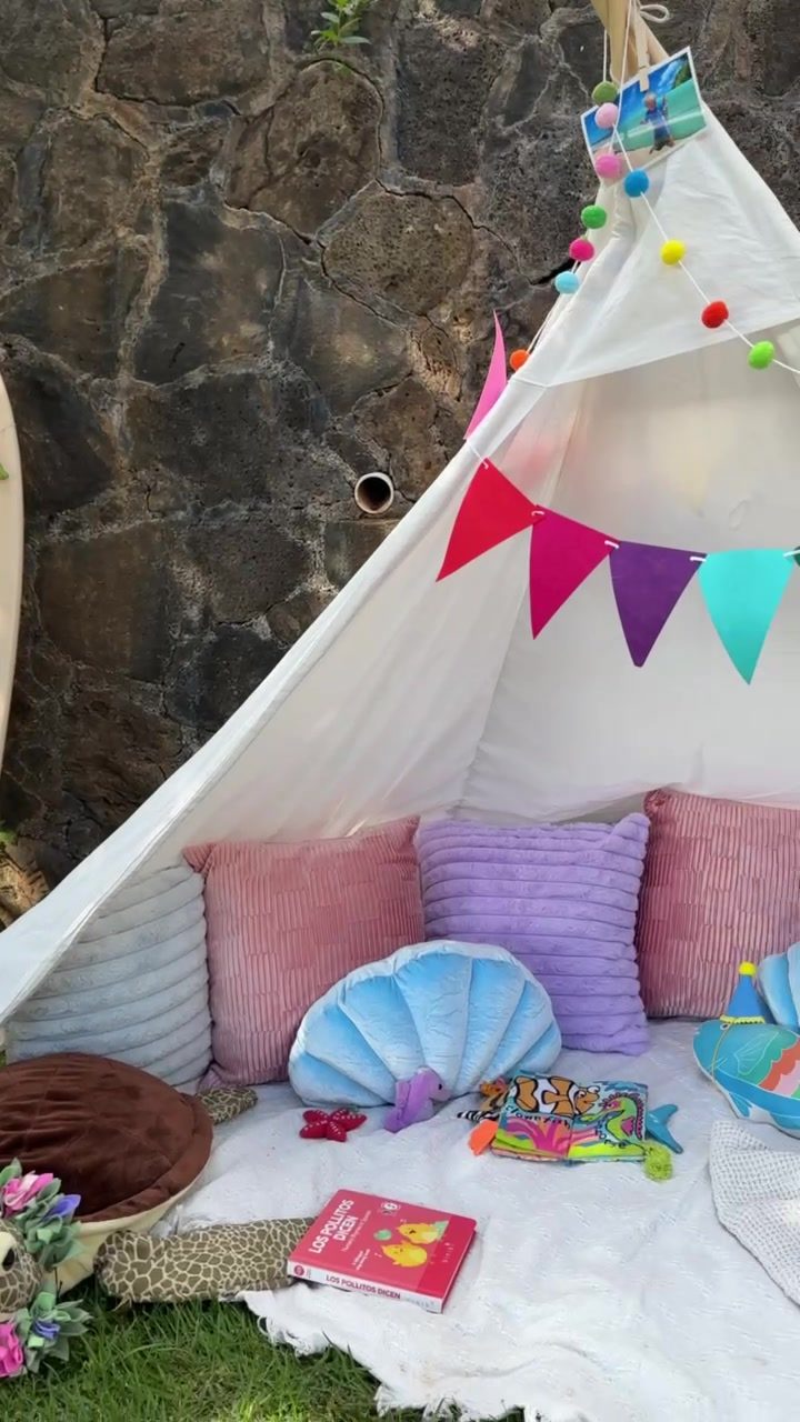 Kids teepee lounge with bunting, pillows and shell cushions