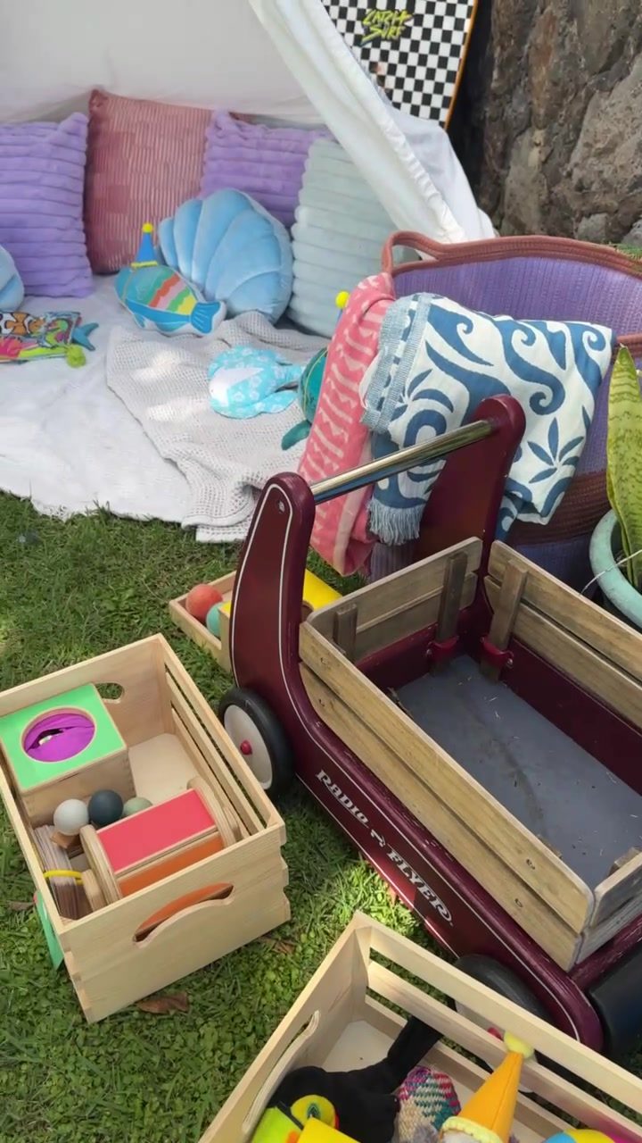 Wooden play crates and a mini lounge set up for little guests
