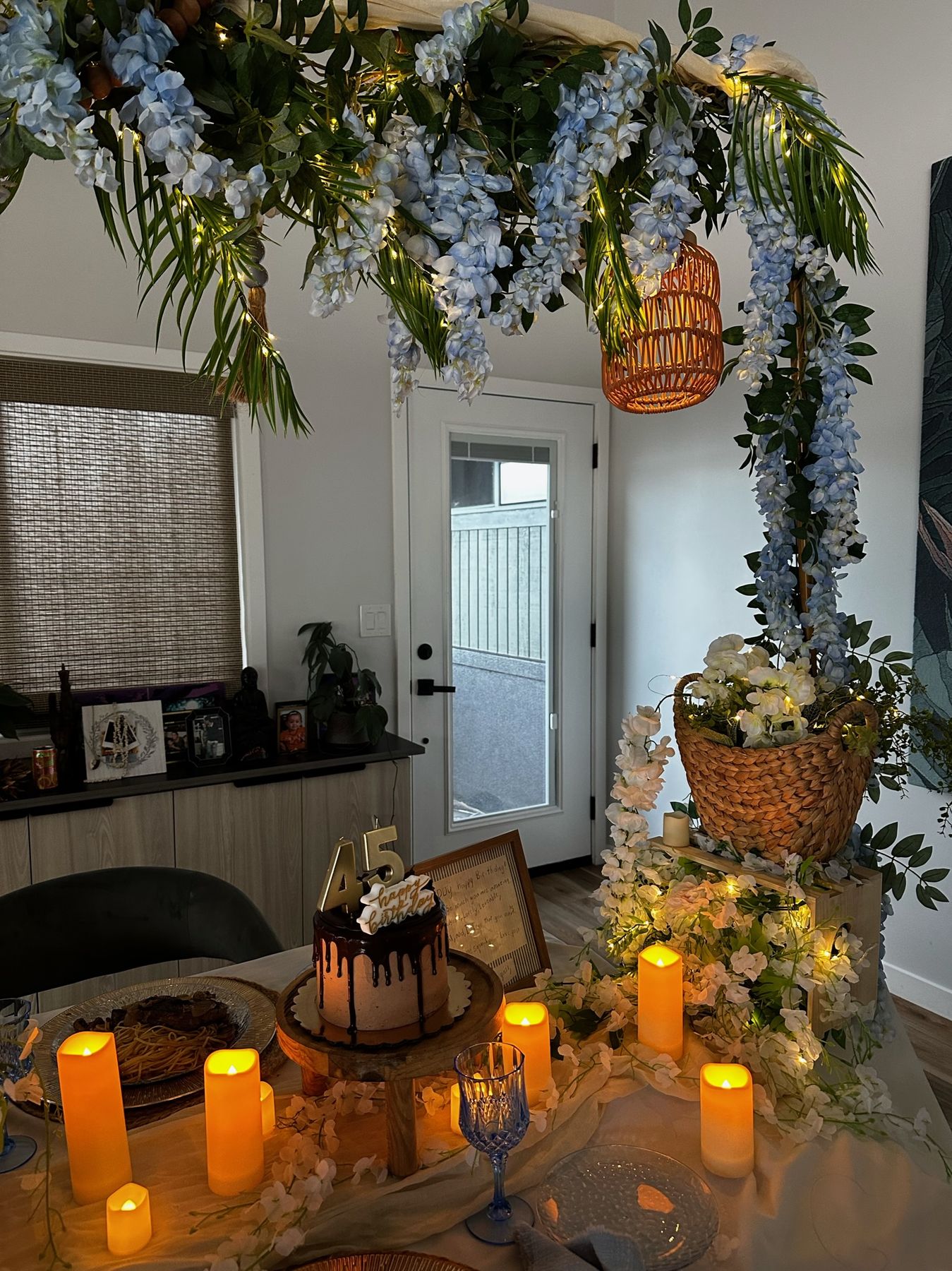 Glowing candles and a chocolate drip cake on the styled dinner table