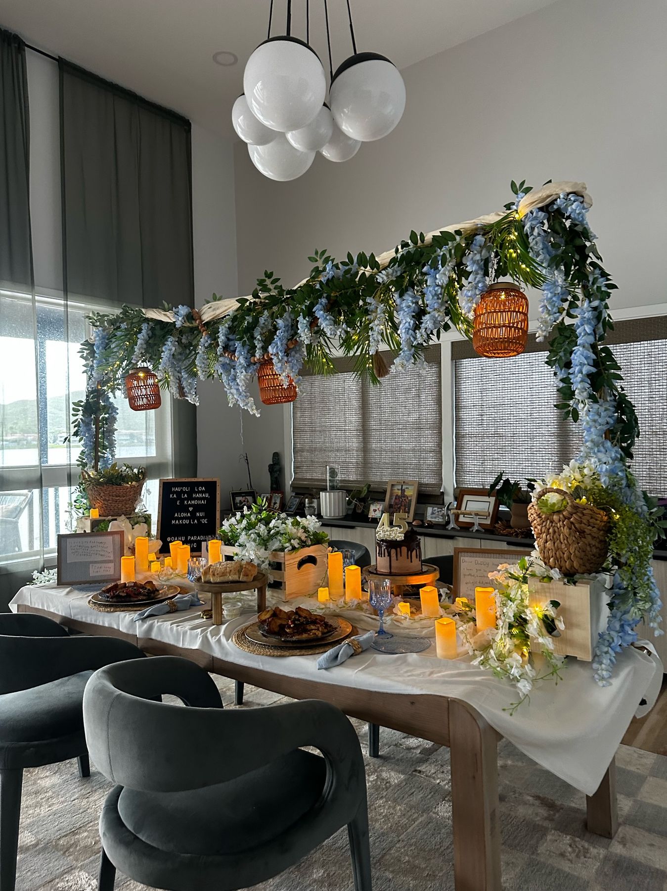 The full candlelit dinner room with wisteria canopy and ocean-view windows