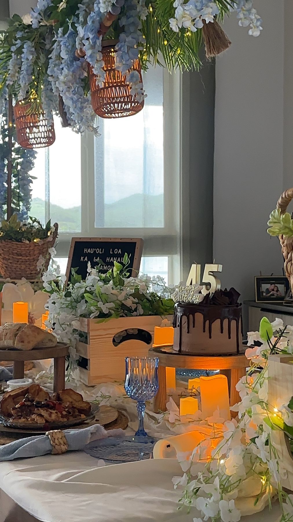 Number 45 cake topper, candles and white florals on the dinner table