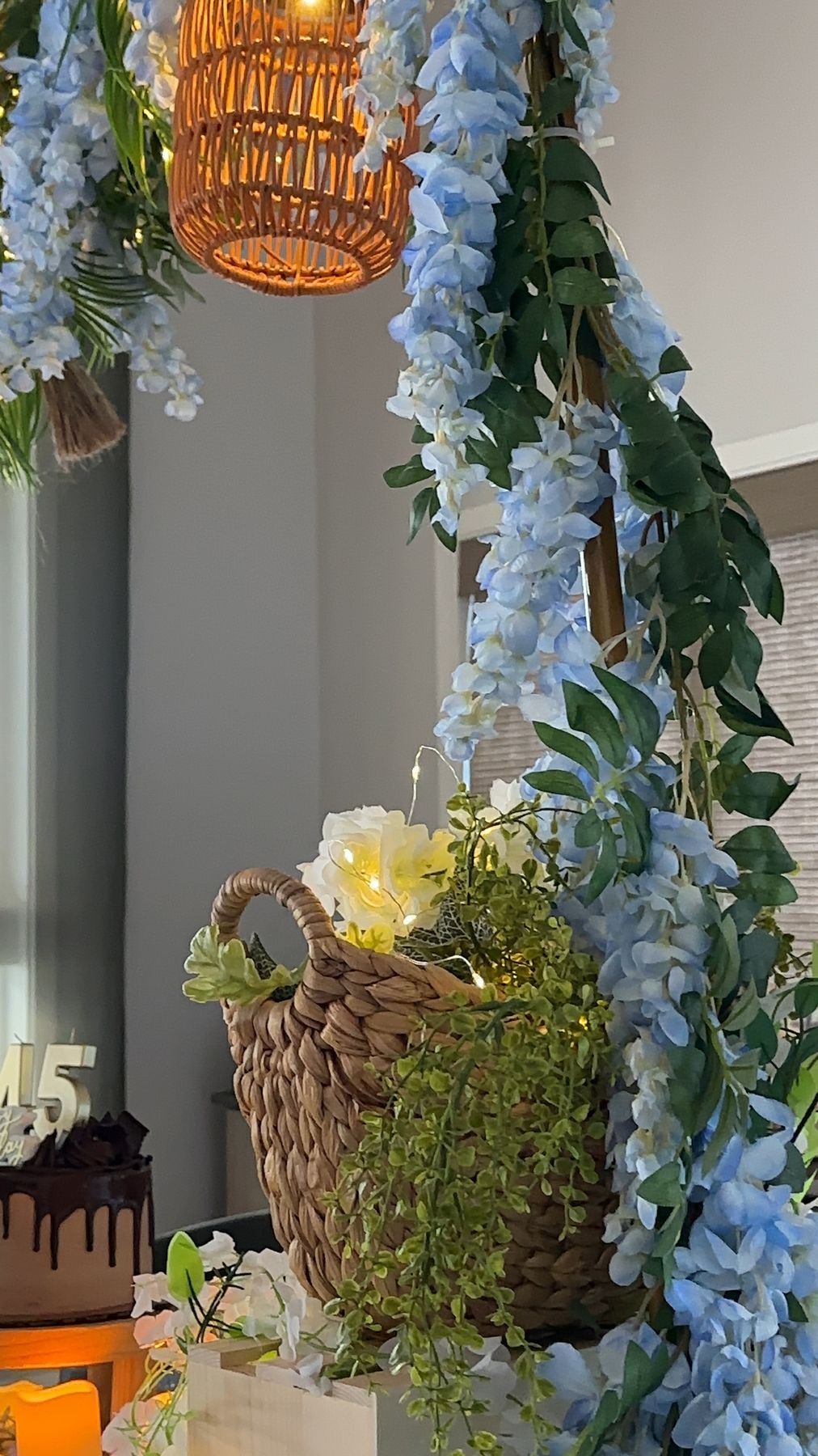 Hanging flower basket and wisteria above the celebration cake