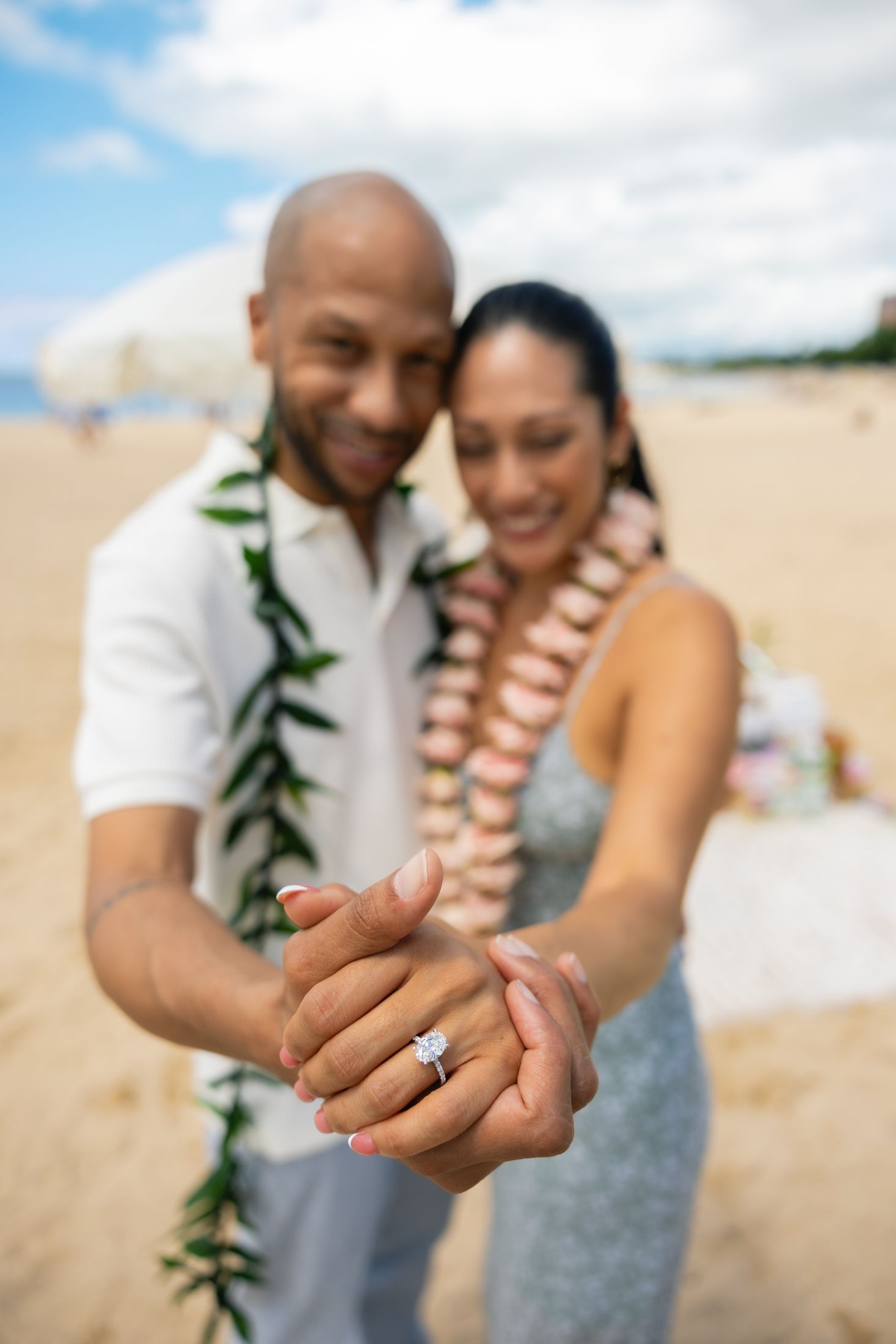 Close-up of the couple holding hands with the new engagement ring