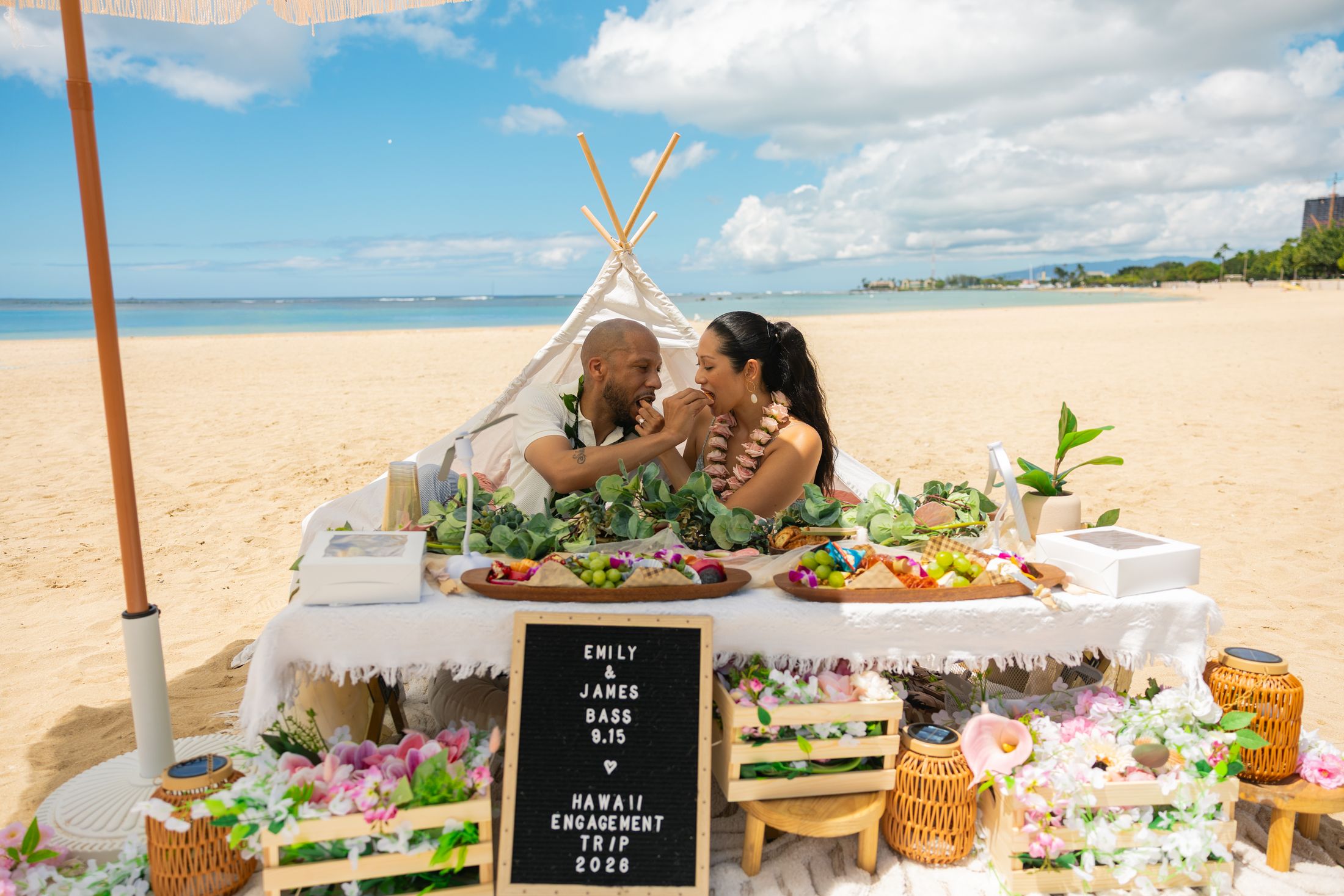 The couple shares the grazing table inside the styled teepee