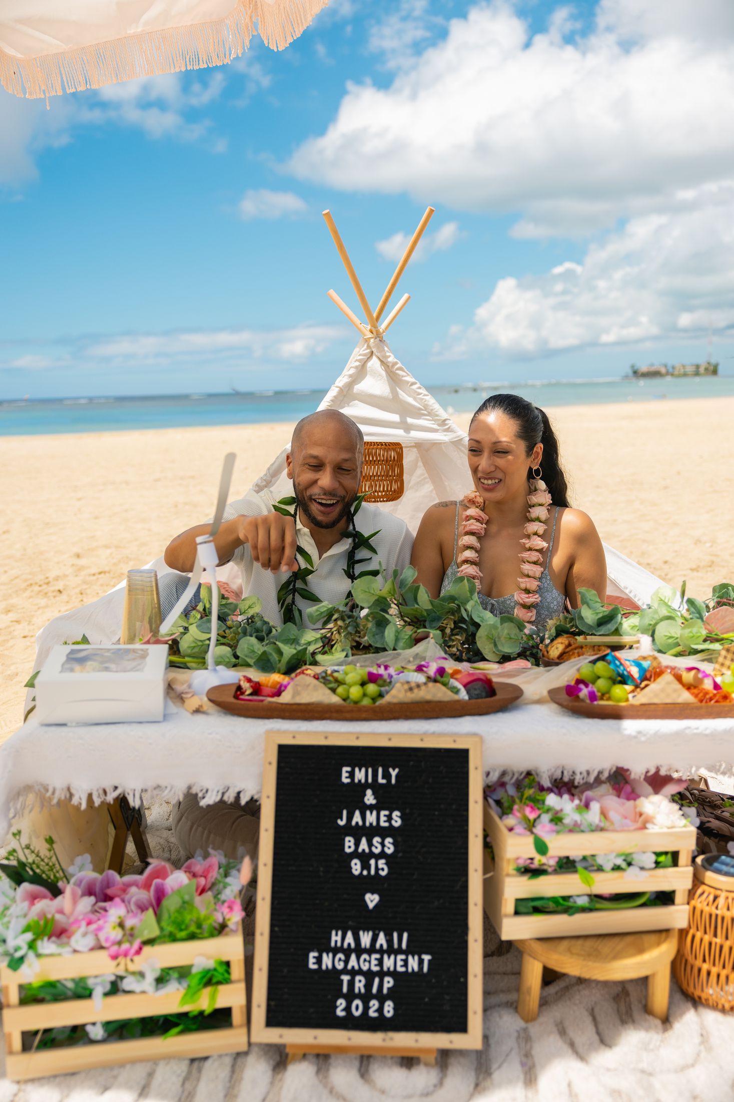 The couple at the grazing table with their custom letterboard sign