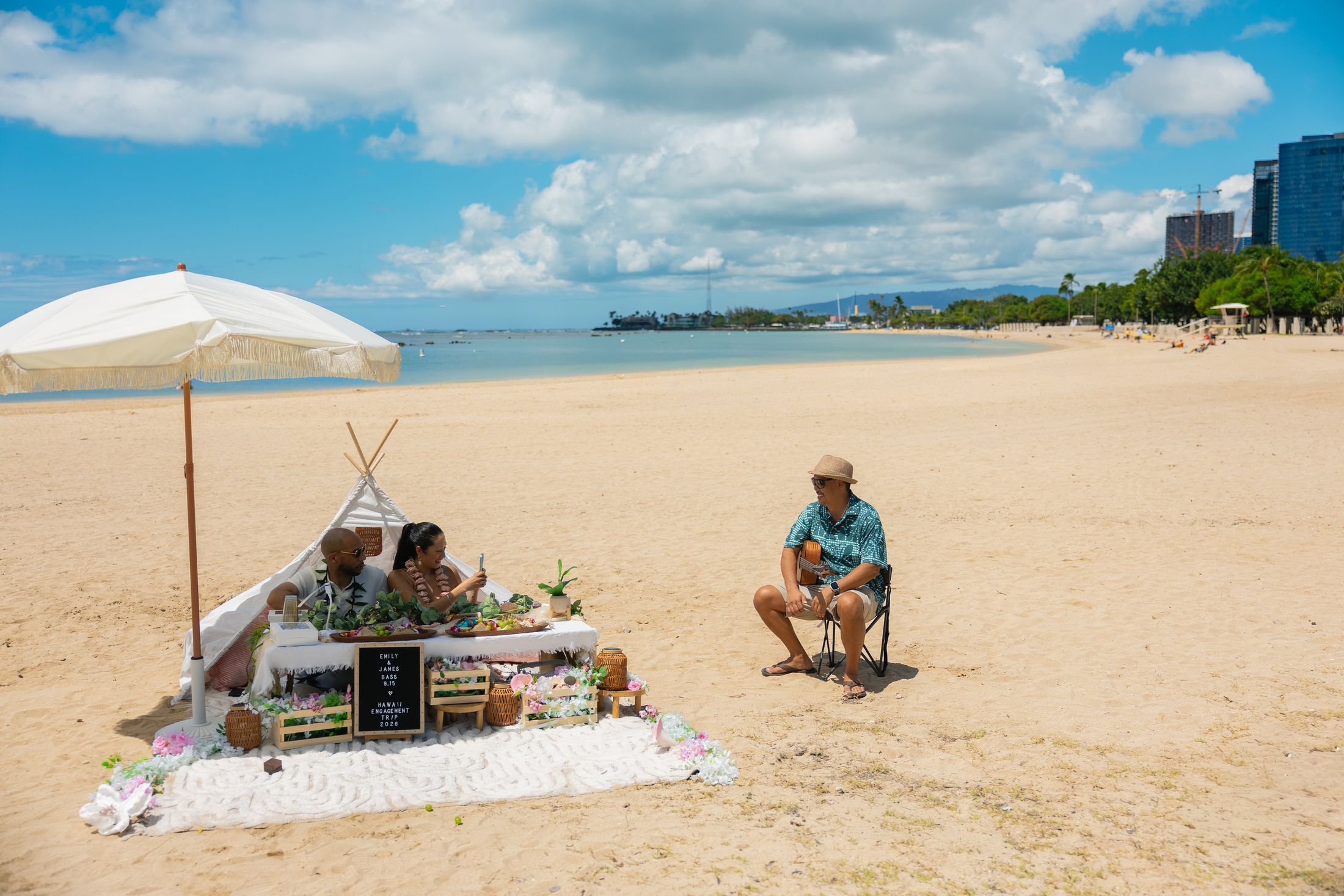 Live guitarist serenading the couple at their beach picnic