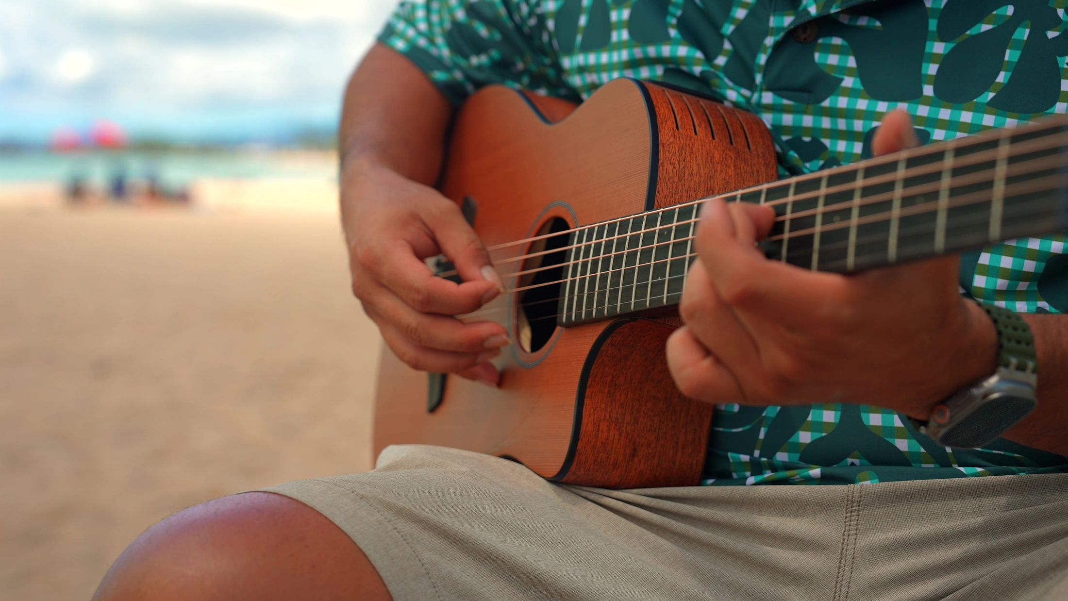 Close-up of the live guitarist playing on the beach