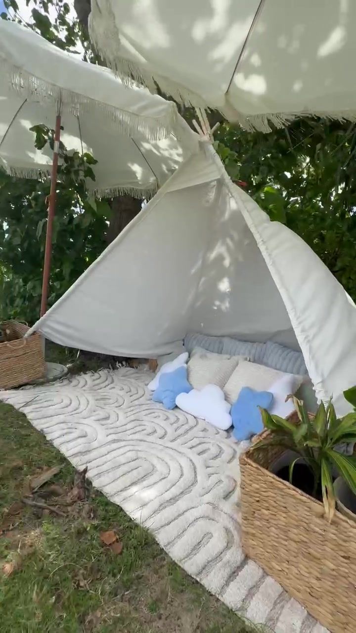 White teepee lounge with cloud pillows and woven baskets