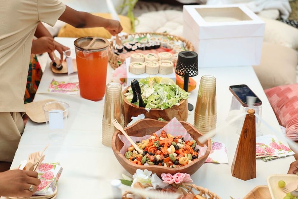 Guests serving themselves from salad bowls and juice at the soirée