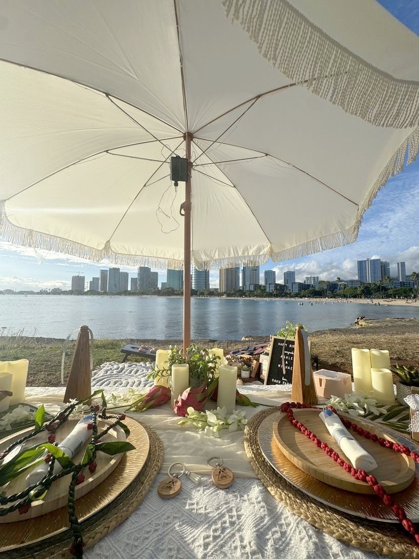 Fringed umbrella picnic table with the Honolulu skyline across the water
